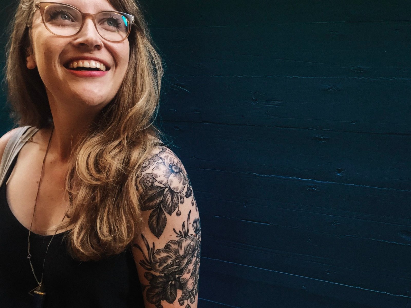 woman-with-tattoos-glasses--e1631679075970.jpg